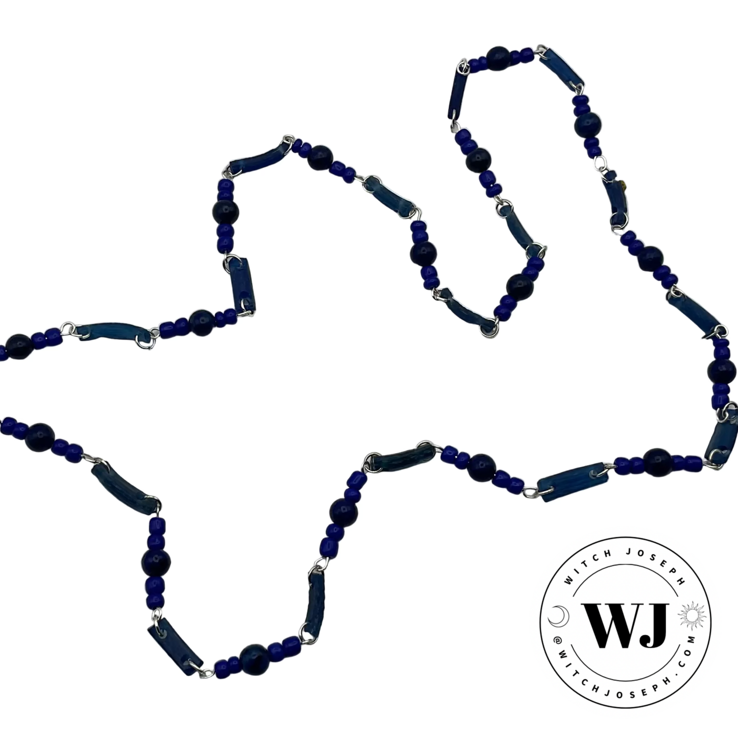 Blue beaded necklace made from Ancient Roman glass beads and lapis with contemporary blue seed beads with silver tone links displayed on a white background with 'Witch Joseph' logo.