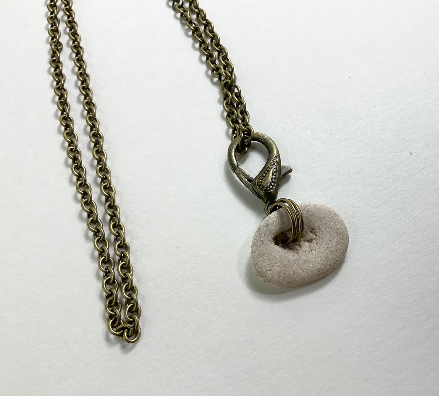 Holey Stone Necklace on bronze tone chain