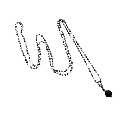 Silver tone ball chain necklace with a black lava stone pendant on a white background