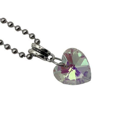 Heart-shaped crystal pendant on a ball chain against a white background