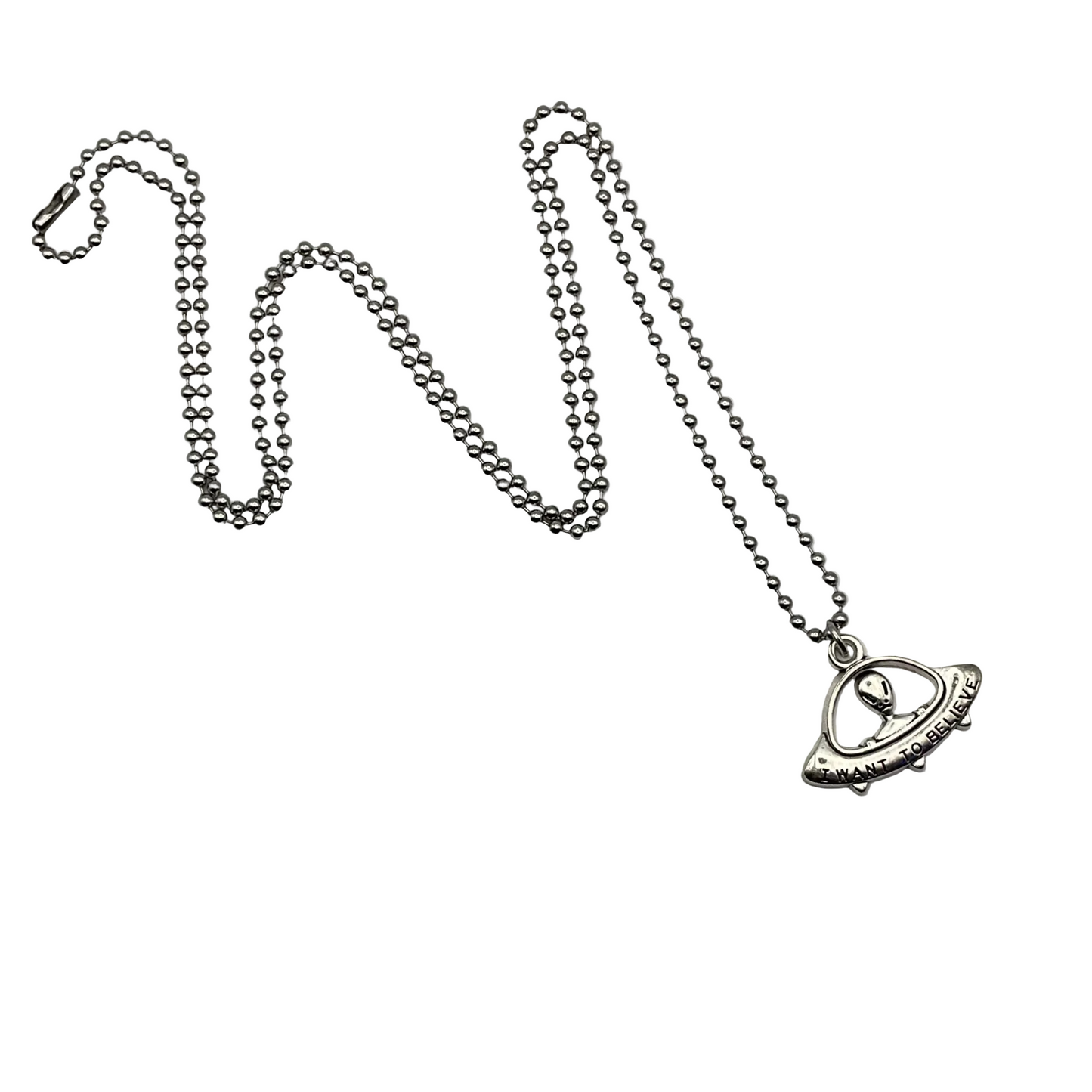 Silver tone flying saucer ball chain necklace with a flying saucer with alien “I want to believe” pendant on a white background