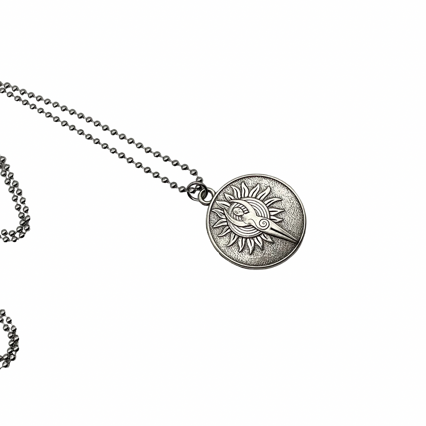 Silver tone charm necklace with a round Sun Goddess pendant on a white background