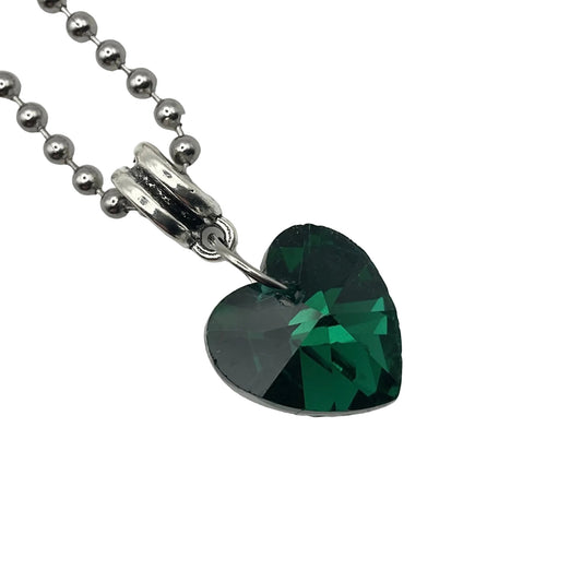 Heart-shaped green crystal pendant on a silver tone ball chain against a white background