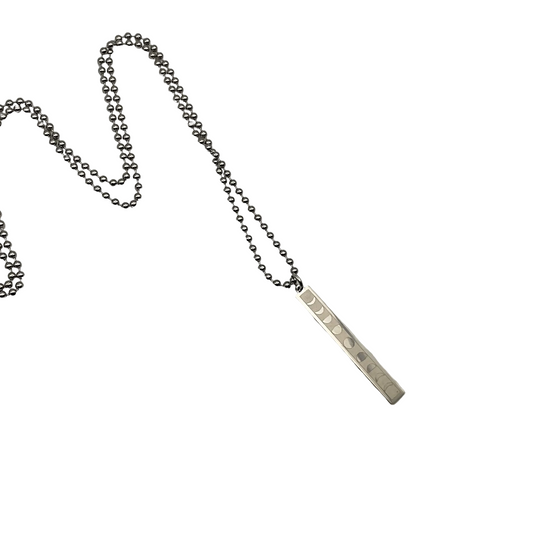 Steel bar pendant depicting the lunar phases on a silver tone ball chain against a white background.