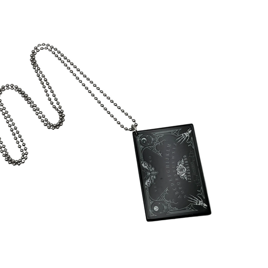 Black rectangular Ouija Board pendant with ball chain on a light white background