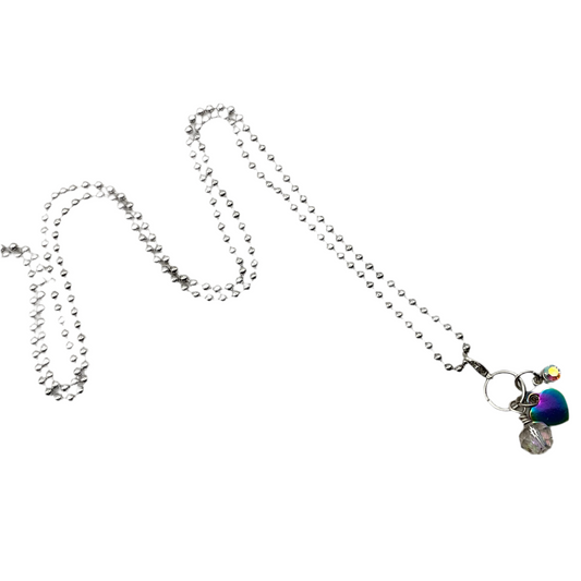 Silver tone necklace with Heart pendant and sparkling beads on a white background