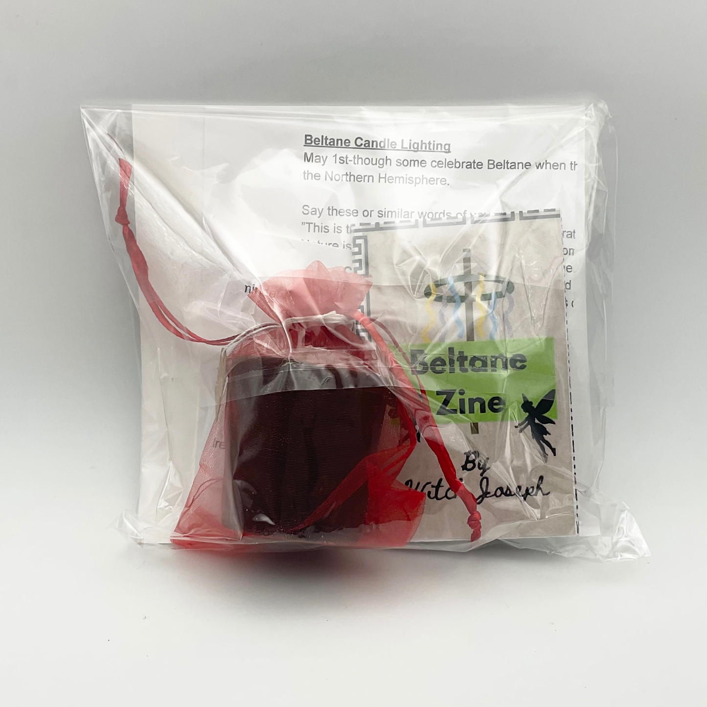 Transparent Packaged Beltane candle and zine with instructions on a white background
