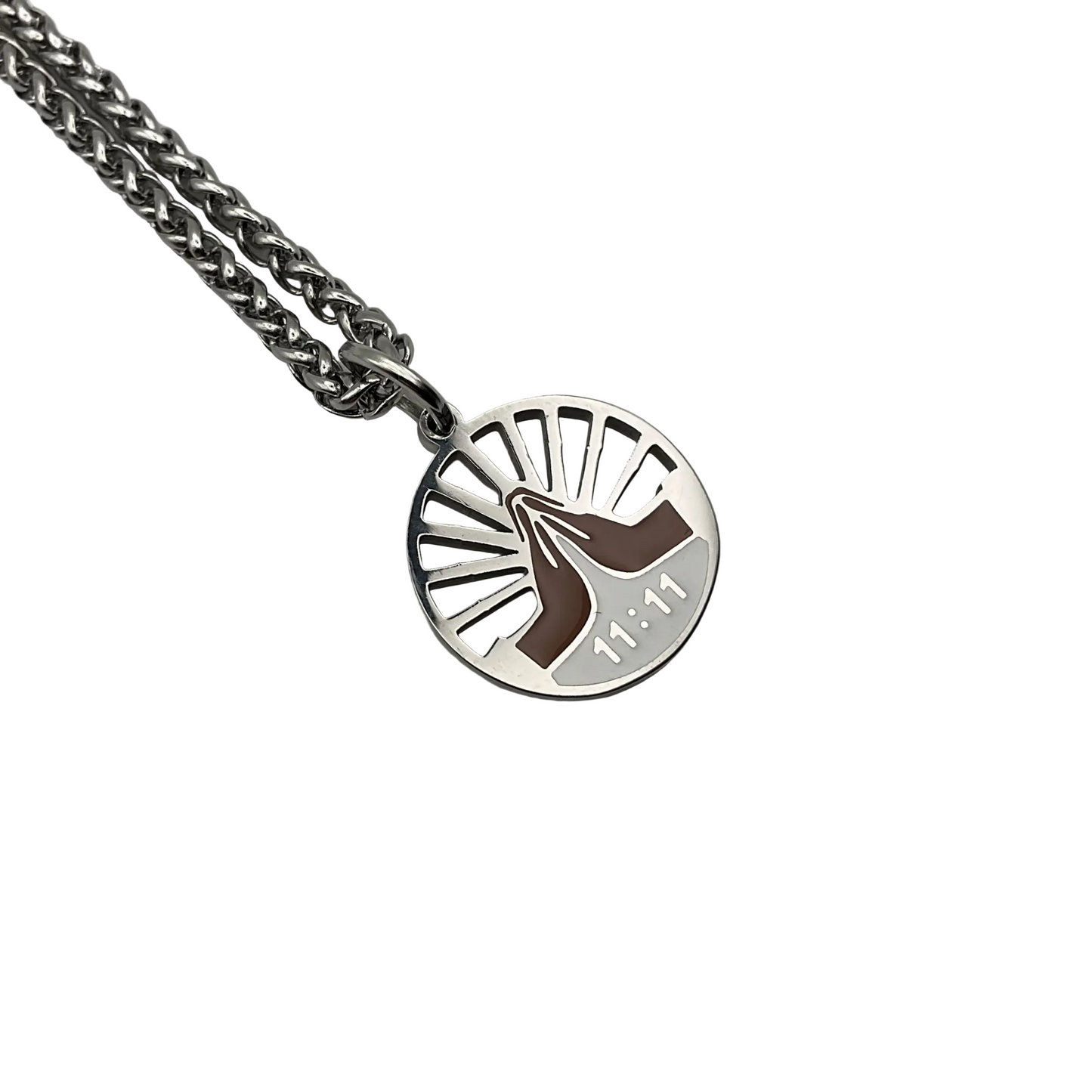 Silver tone necklace with a round  eleven eleven pendant with praying hands on a white background