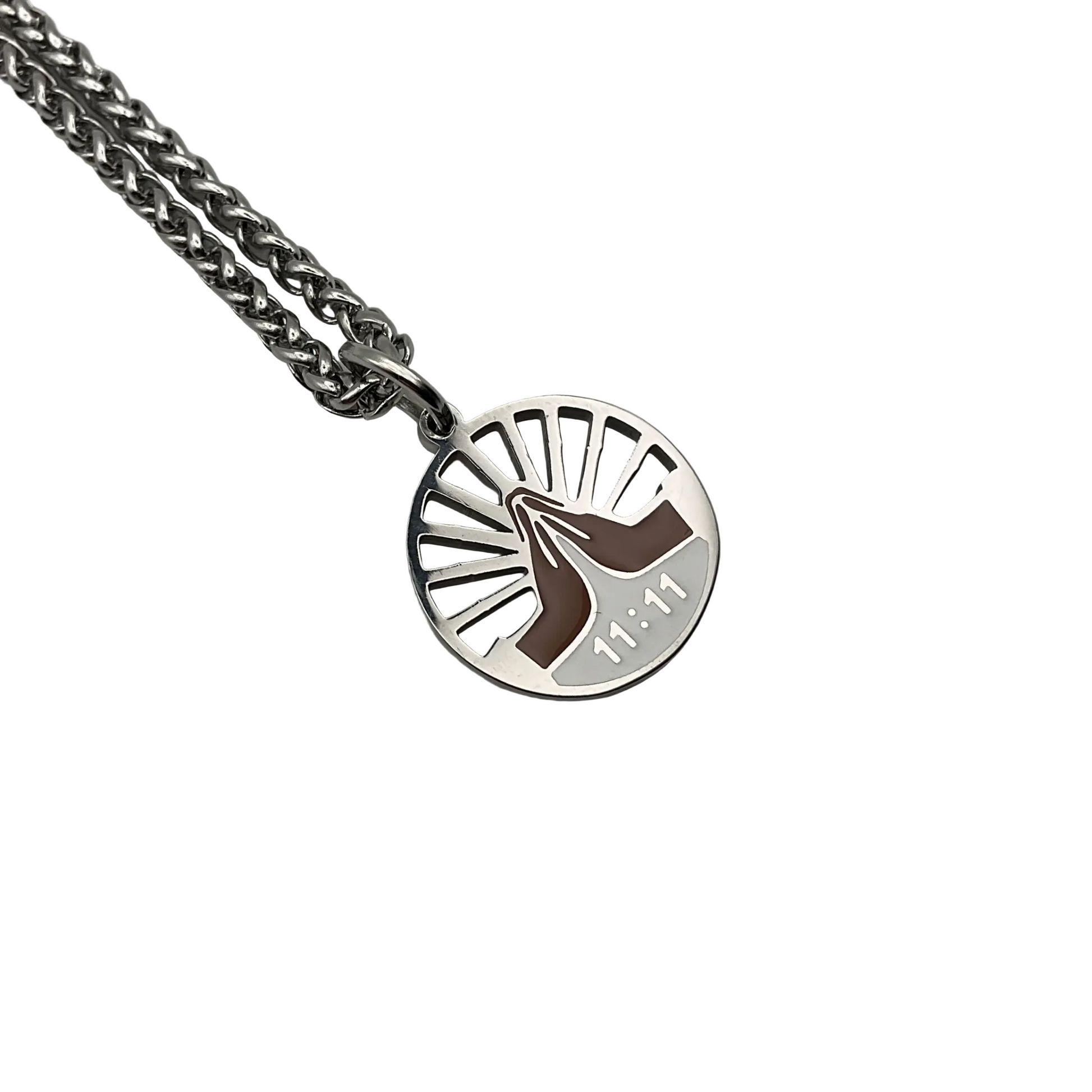 Silver tone necklace with a round  eleven eleven pendant with praying hands on a white background