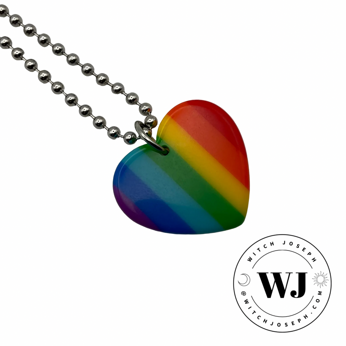 Rainbow heart-shaped acrylic pendant on a ball chain displayed on a white background with the Witch Joseph logo