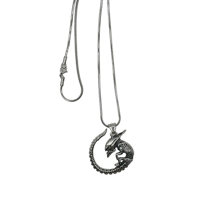 Silver tone necklace with a unique alien baby monster pendant on a white background