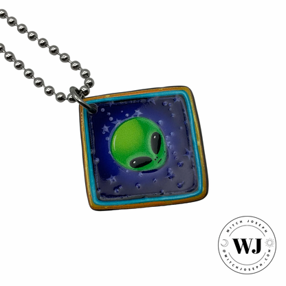 The Witch Joseph Alien face charm necklace on a silver tone ball chain displayed against a white background with the Witch Joseph logo