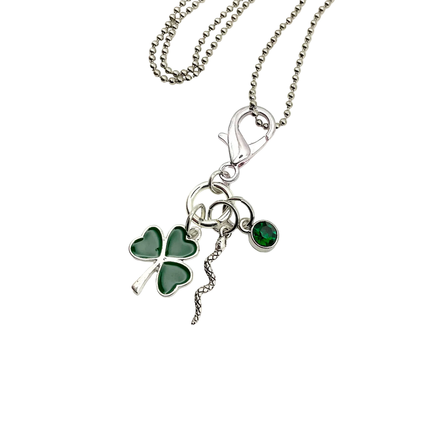 All Snakes Day Charm Necklace with a green shamrock, silver tone snake and a green crystal pendant on a white background