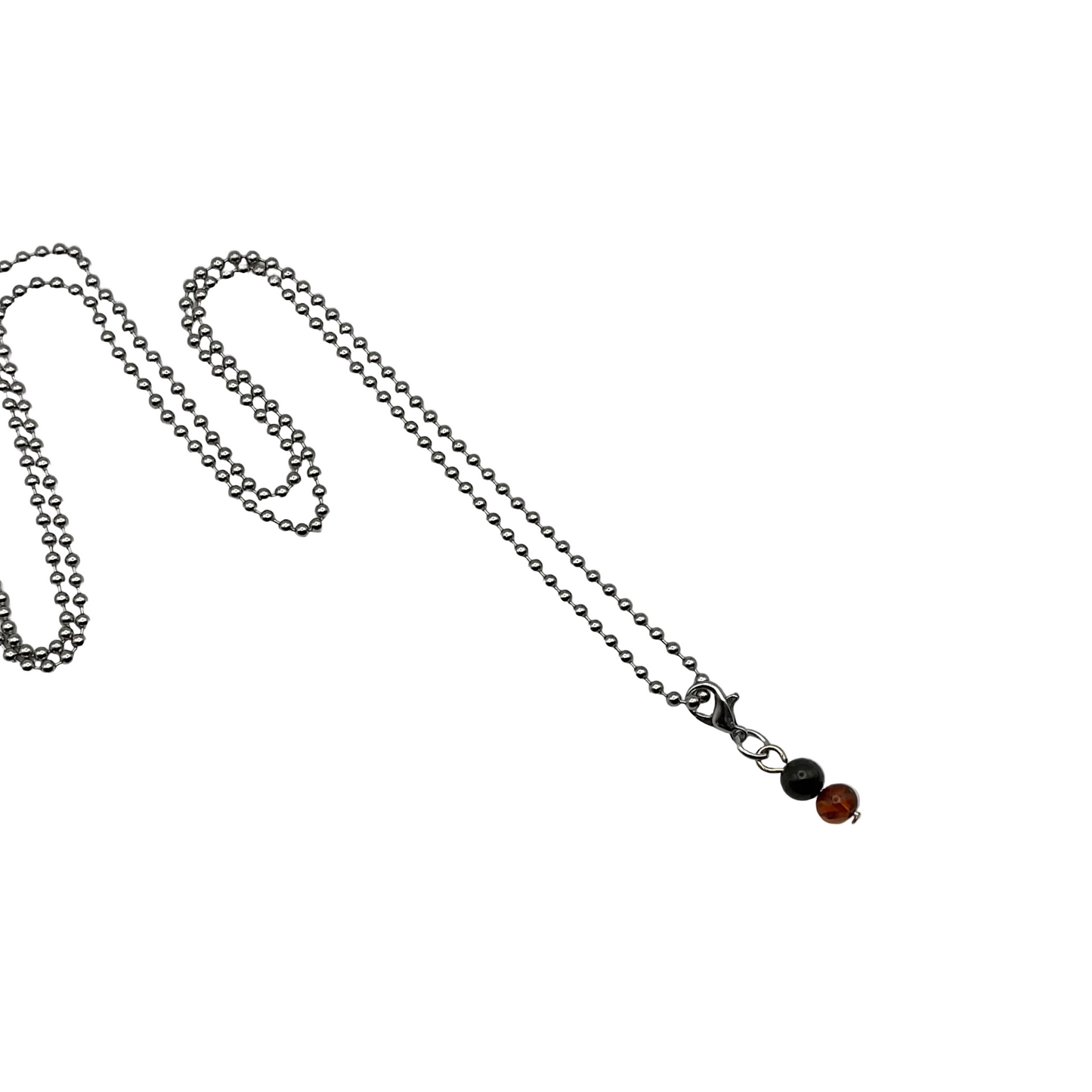 Silver tone ball chain necklace with a small Amber and Jet Bead charm on a white background