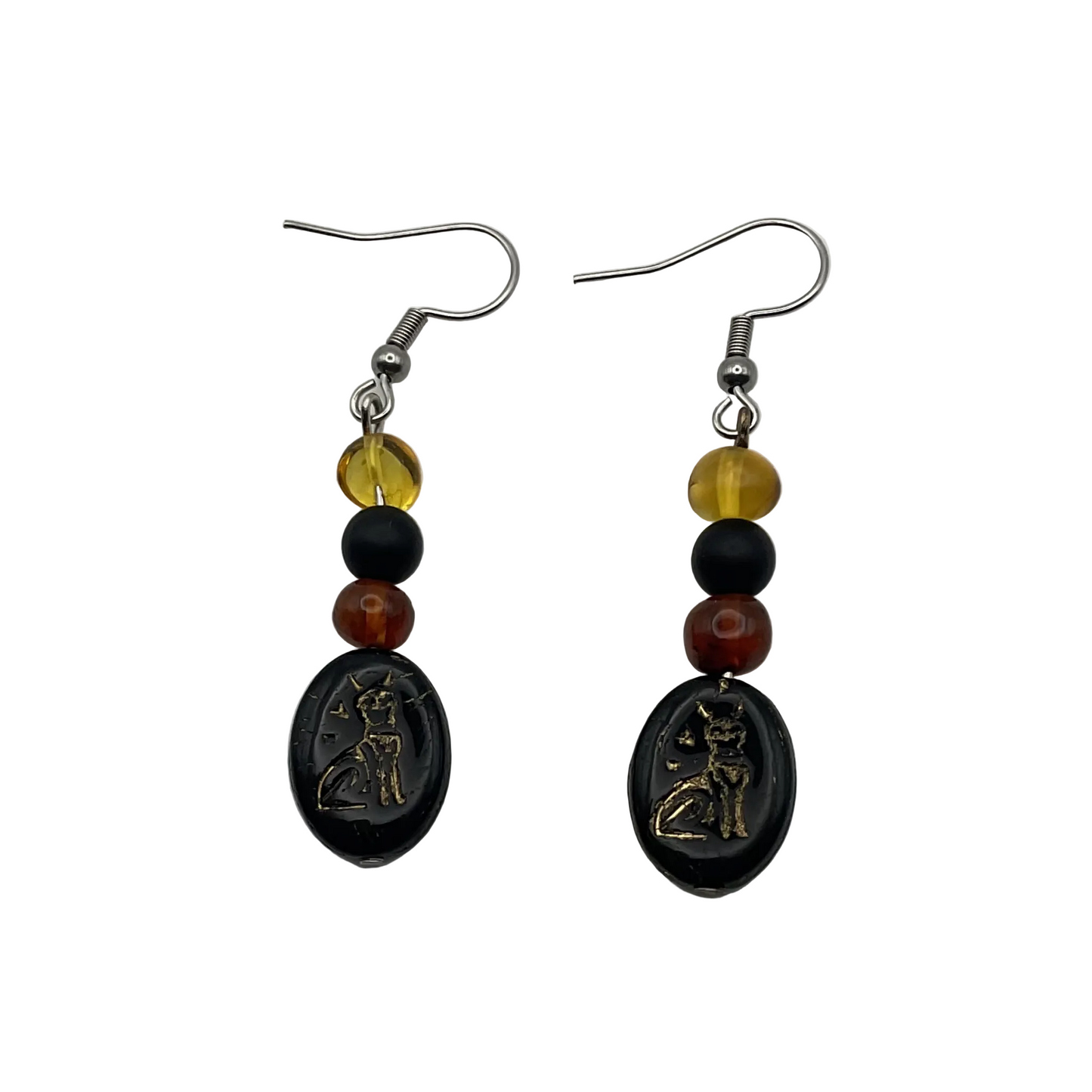 Pair of Bastet amber and jet beaded earrings with cat glyph bead on a white background
