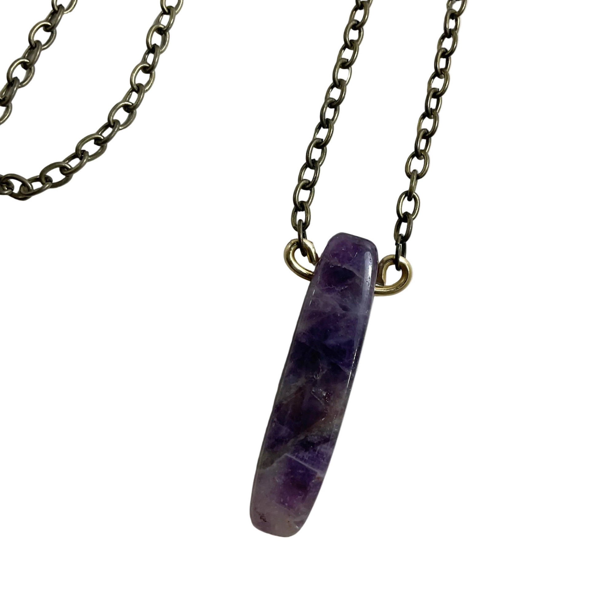 Bronze tone Necklace with a purple parrot wing cut amethyst stone pendant on a white background