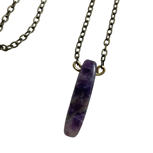 Bronze tone Necklace with a purple parrot wing cut amethyst stone pendant on a white background