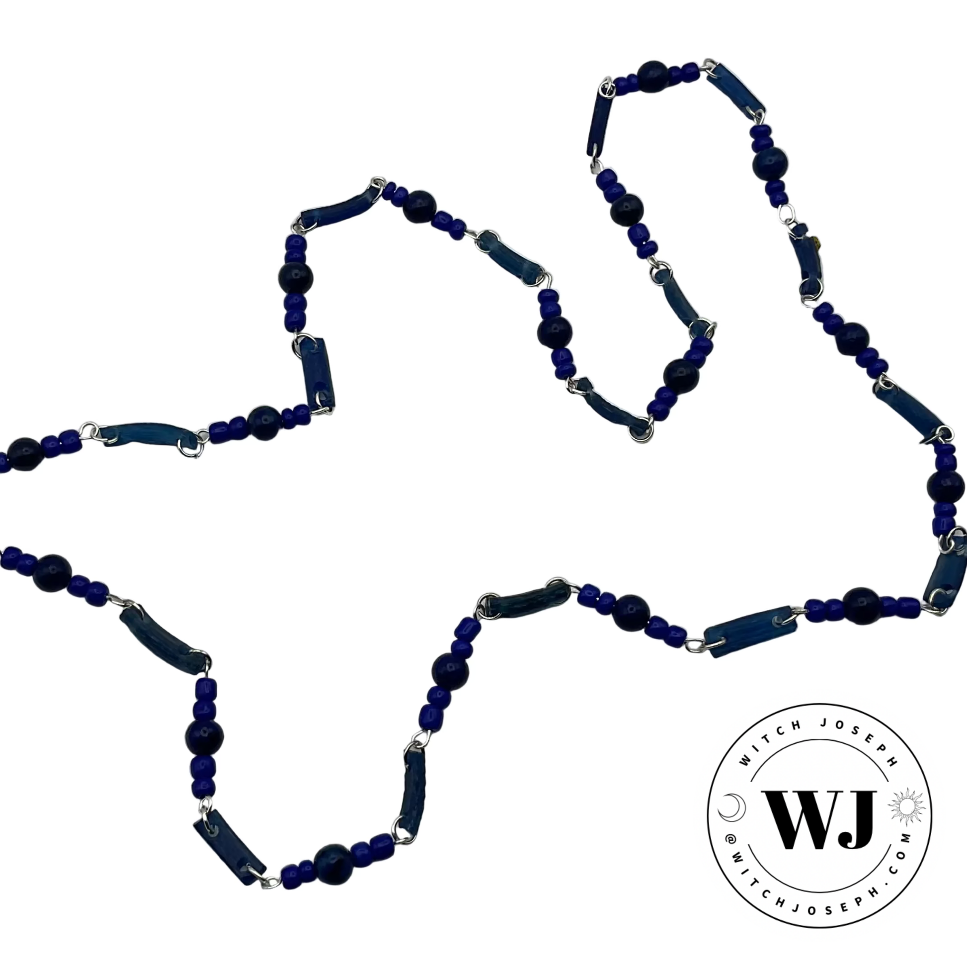 Blue beaded necklace made from Ancient Roman glass beads and lapis with contemporary blue seed beads with silver tone links displayed on a white background with 'Witch Joseph' logo.