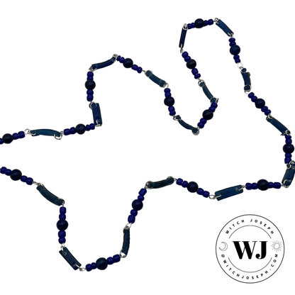 Blue beaded necklace made from Ancient Roman glass beads and lapis with contemporary blue seed beads with silver tone links displayed on a white background with 'Witch Joseph' logo.
