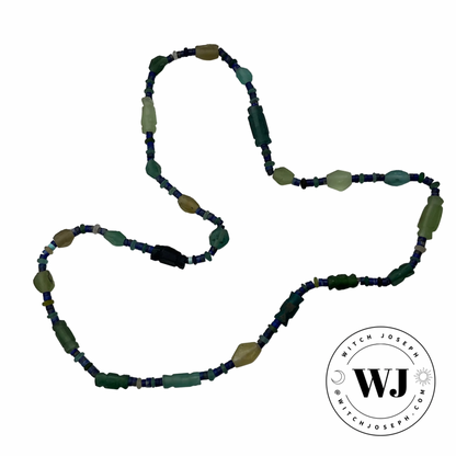 Beaded necklace with ancient Roman glass and lapis lazuli green and blue beads necklace displayed on a white background, featuring the logo 'Witch Joseph'.