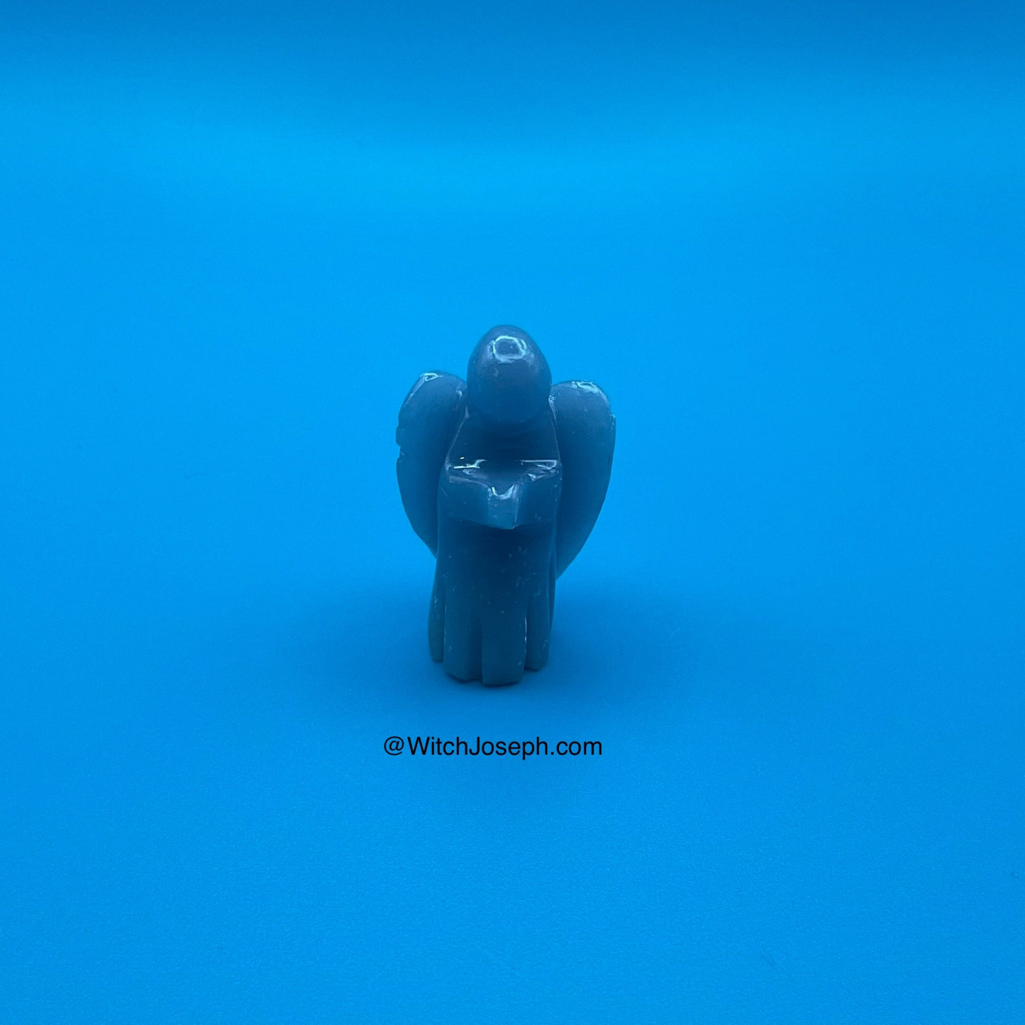 Blue angelite angel figure on a blue background with 'WitchJoseph.com' text.