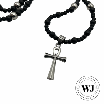 Silver tone Ankh necklace with black and silver tone beads displayed against a white background with the Witch Joseph Logo