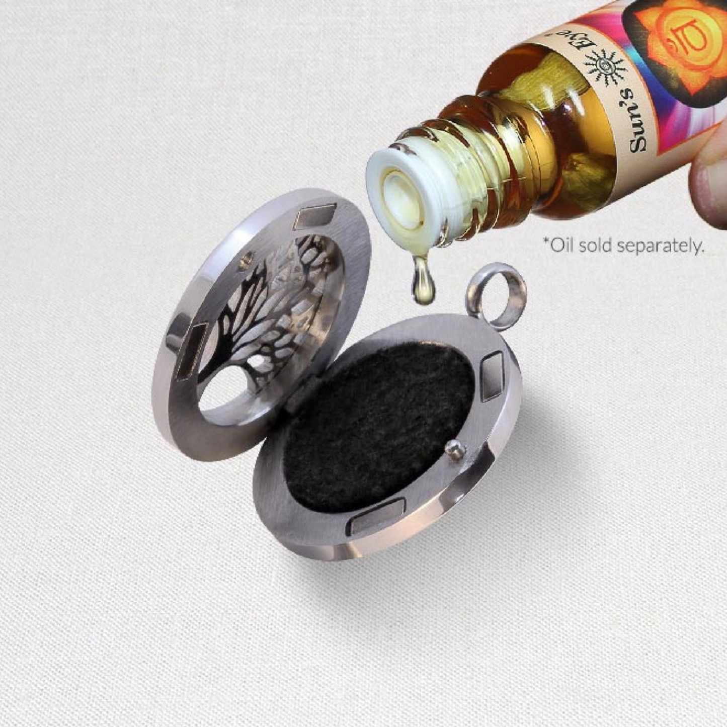 Aromatherapy Heart Locket being loaded with fragrance oil against a white background.