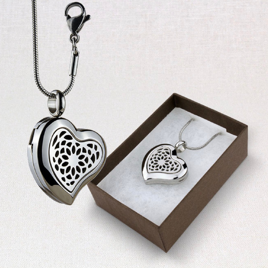 Aromatherapy Heart Locket from suns eye shown hanging and also in the presentation box against a white background.
