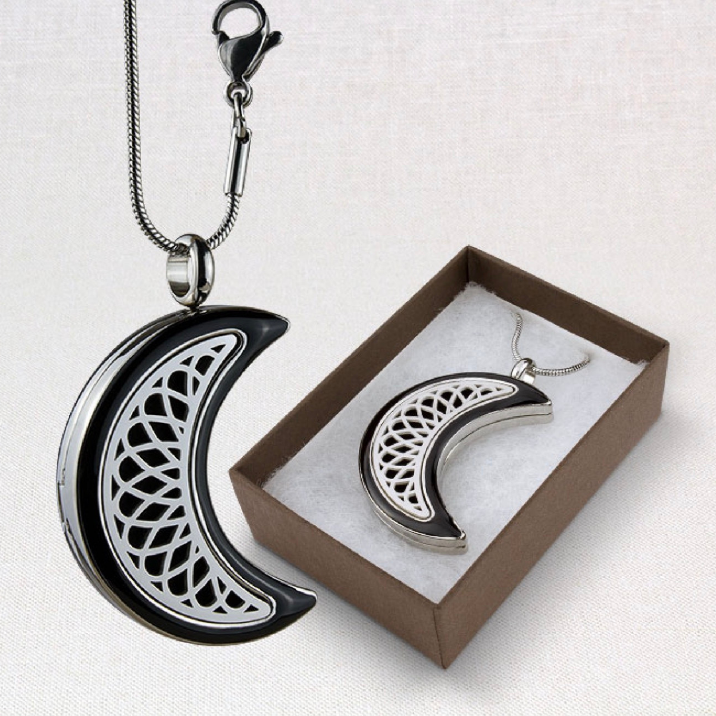 Aromatherapy Moon Locket from Suns Eye shown hanging and also in a presentation box against a white background.