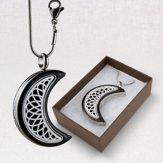 Aromatherapy Moon Locket from Suns Eye shown hanging and also in a presentation box against a white background.