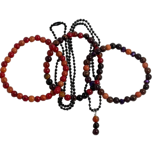 Set of autumn themed beaded bracelets and necklace with multicolor beads on a white background
