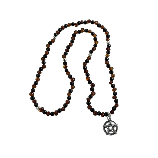 Baltic amber and Russian jet Beaded necklace with sterling silver bead accents and with a sterling silver pentacle pendant displayed on a white background