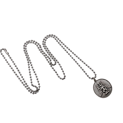 Silver tone necklace with a circular Baphomet pendant on a white background.