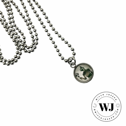 small Bastet charm necklace displayed against a white background with the Witch Joseph Logo
