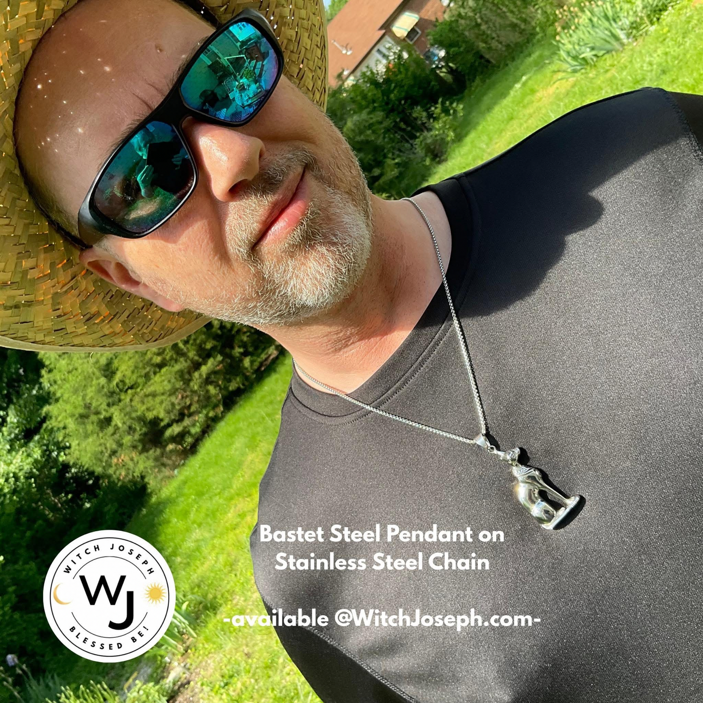 Man wearing sunglasses and a straw hat modeling our Bast cat pendant necklace…standing outdoors in the Garden with the Witch Joseph logo