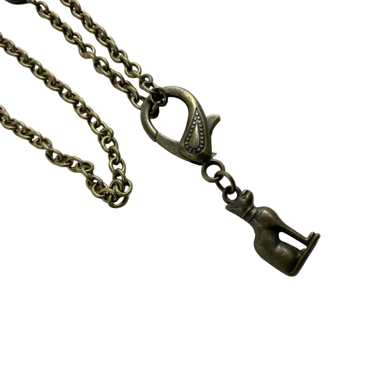 An antiqued bronze-toned metal necklace featuring a lobster clasp and a dangling pendant shaped like a seated cat figure, shown on a plain white background.