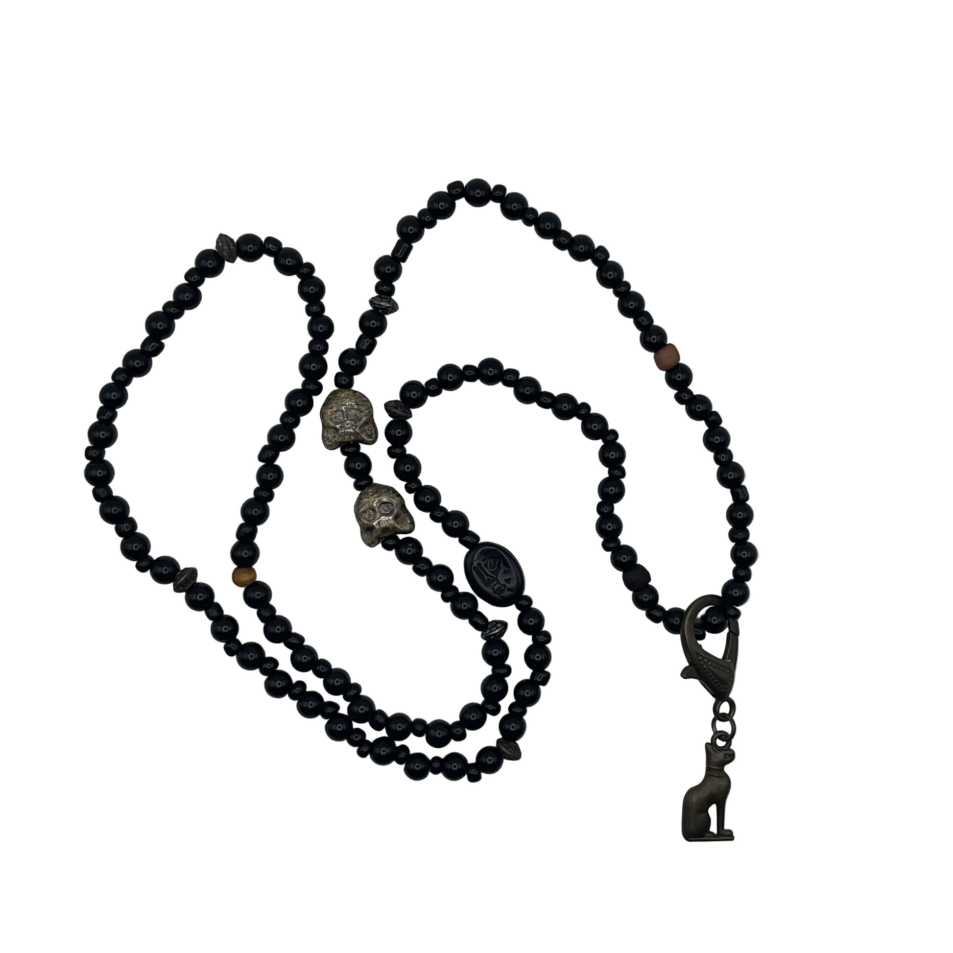 Black beaded necklace with decorative cat bead elements and a bronze tone Bastet cat pendant displayed on a white background