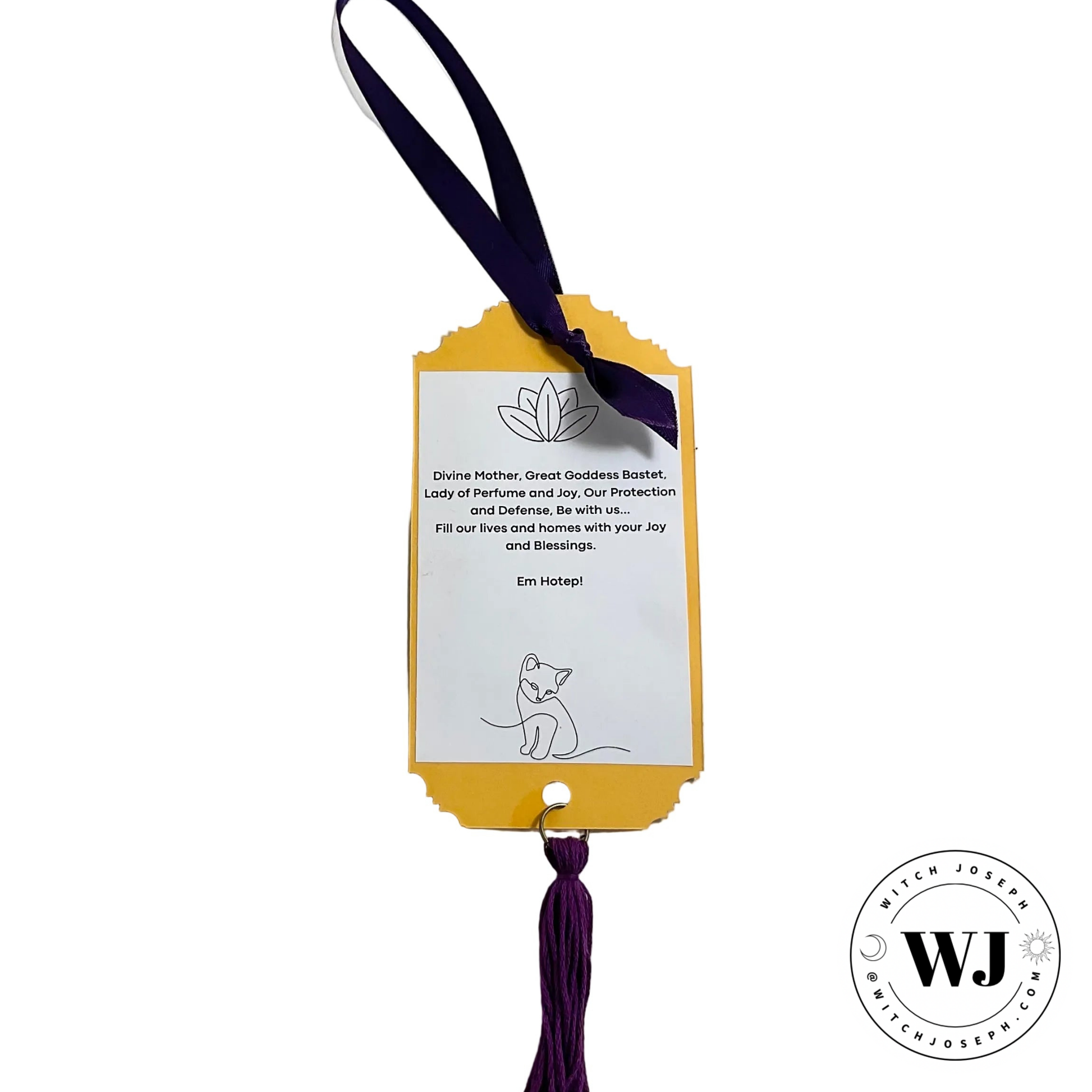 Yellow tag with purple ribbon and text on a white background with prayer to Goddess Bastet featuring the brand 'WJ'.