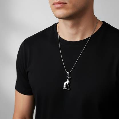 Man wearing a black t-shirt with a silver tone Bastet cat necklace  on a gray background