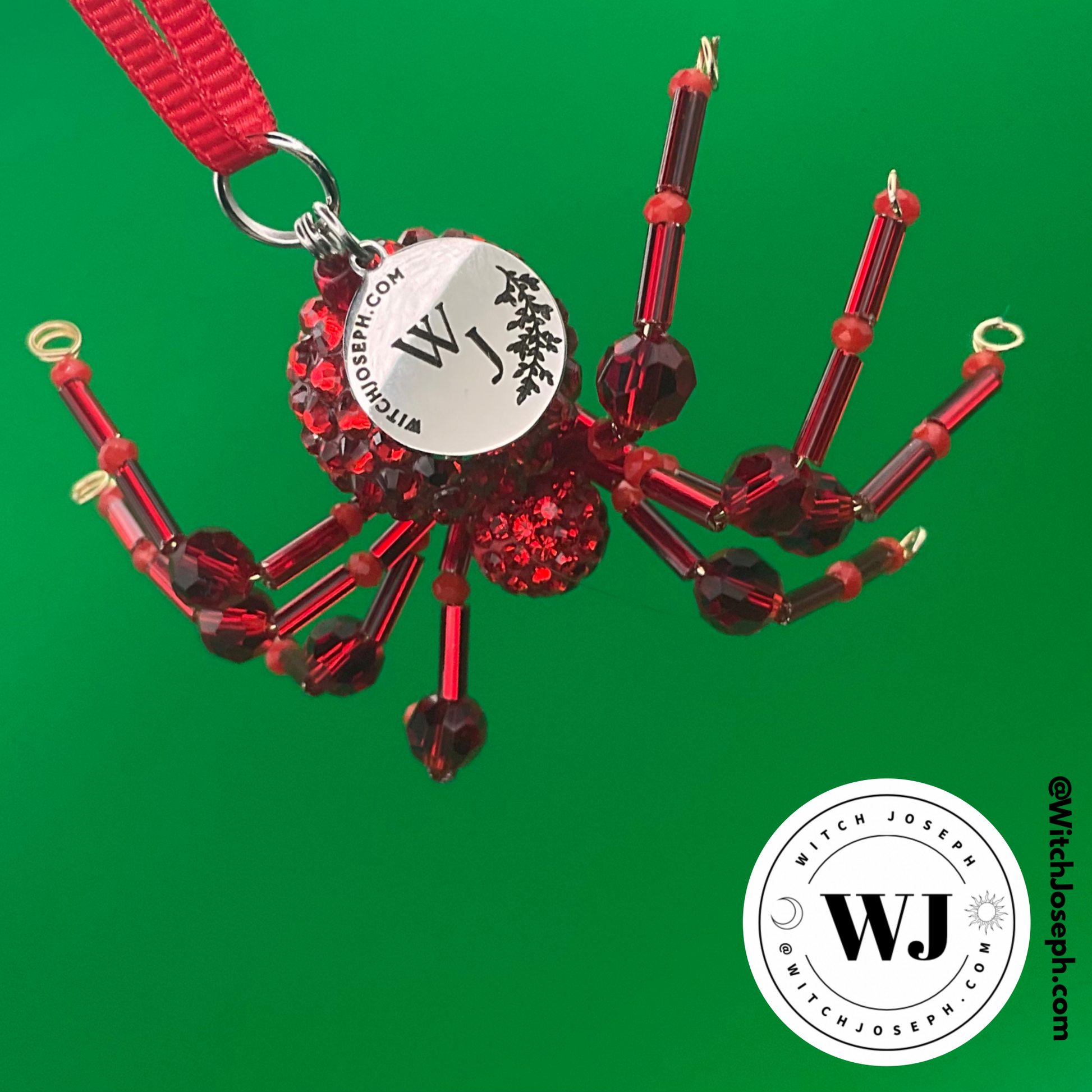Red beaded Spider ornament on green background with the Witch Joseph logo