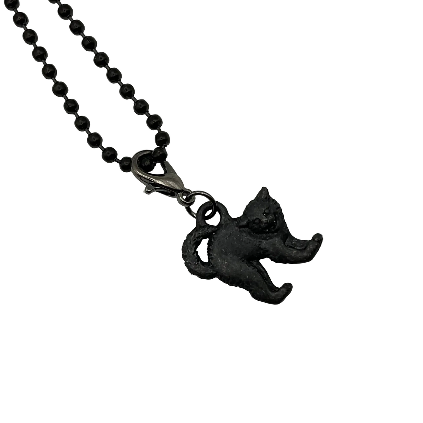 Black cat pendant charm on a black ball chain against a white background