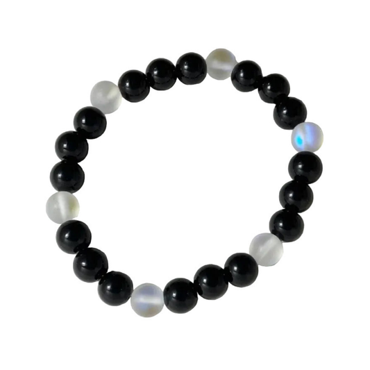 Beaded bracelet with black and refractive beads on a white background