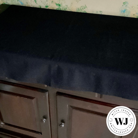 Black Altar cloth shown over a wooden cabinet used as an altar