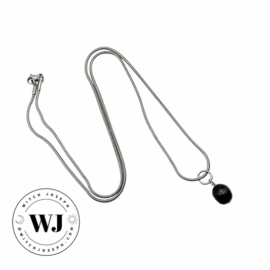 Silver tone necklace with a black pearl drop pendant on a white background, featuring the WJ logo.