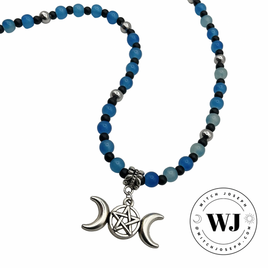 Triple Goddess Necklace with blue and black beads and a triple Goddess pentacle charm displayed on a white background with the Witch Joseph logo