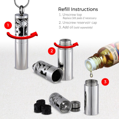 A photo showing the cat Pendulum aromatherapy locket being loaded with frangrance.