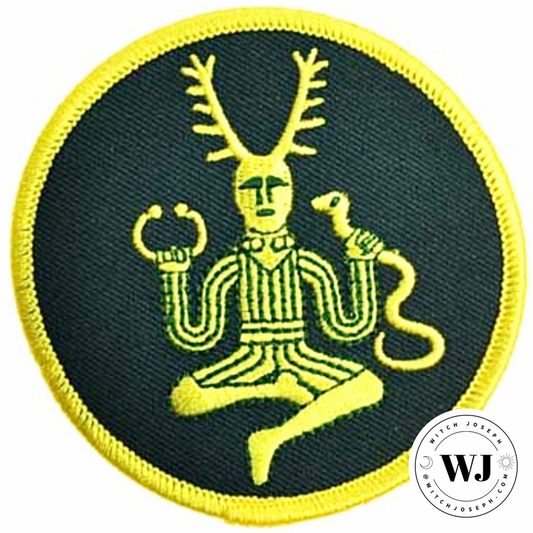 Embroidered patch with a central Cernunnos figure holding a snake and a torque, on a green background with yellow border.