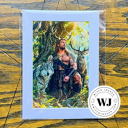 A matted art print featuring a fantasy illustration of Cernunnos with antlers sitting in a forest with a wolf and deer, displayed on a wooden surface with a circular 'Witch Joseph' logo.