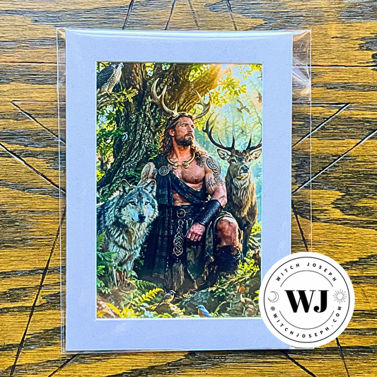 A matted art print featuring a fantasy illustration of Cernunnos with antlers sitting in a forest with a wolf and deer, displayed on a wooden surface with a circular 'Witch Joseph' logo.