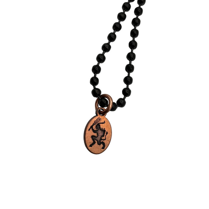 Black ball chain  necklace with a copper Krampus pendant on a white background
